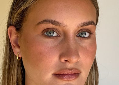 Close-up of a woman's glowing complexion at Glos Skin & Beauty, Helensvale, Queensland, AU.