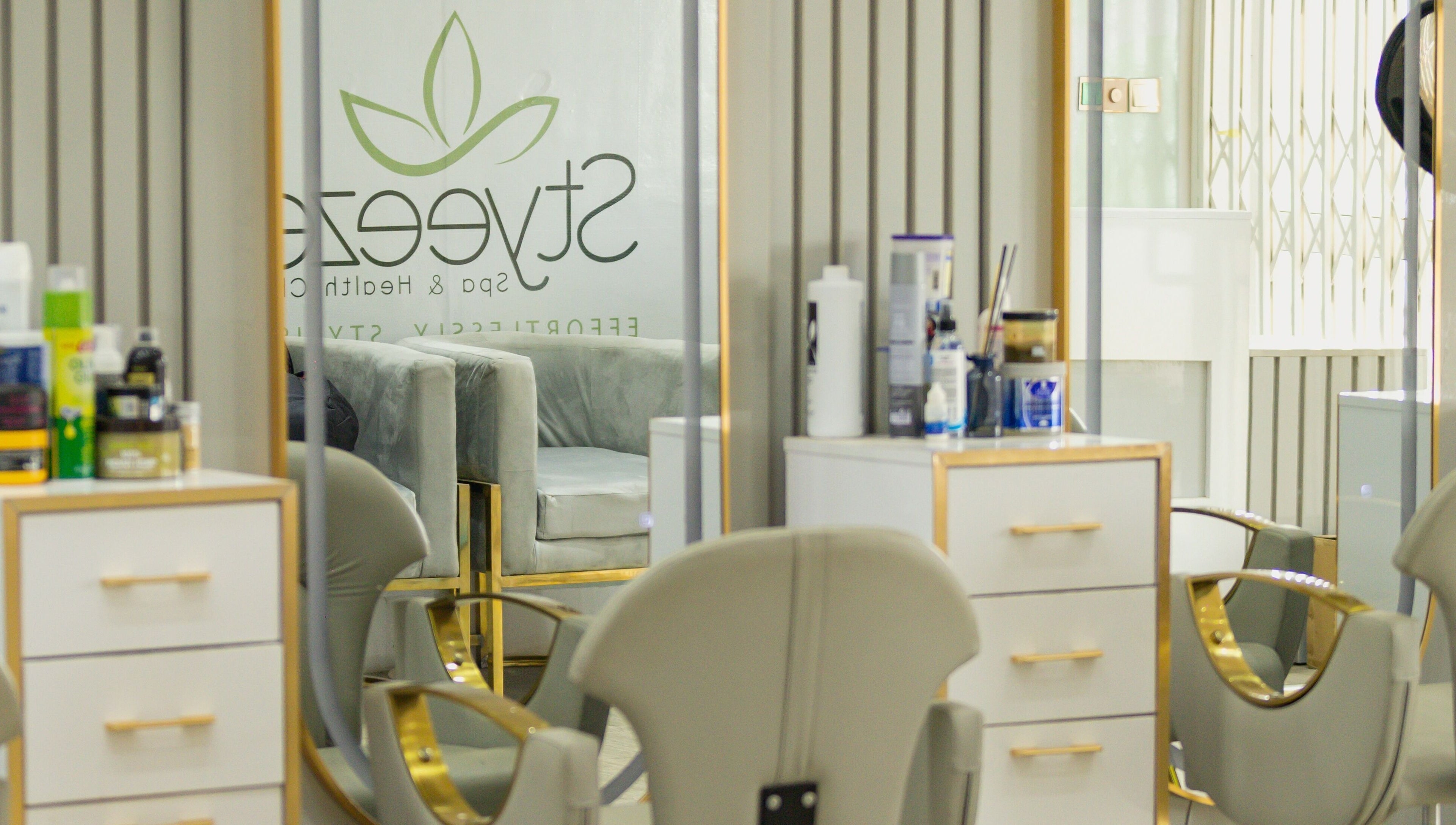 Modern salon interior at Styeeze Spa and Health Club, Greater Accra Region, GH, with stylish mirrors and chairs.