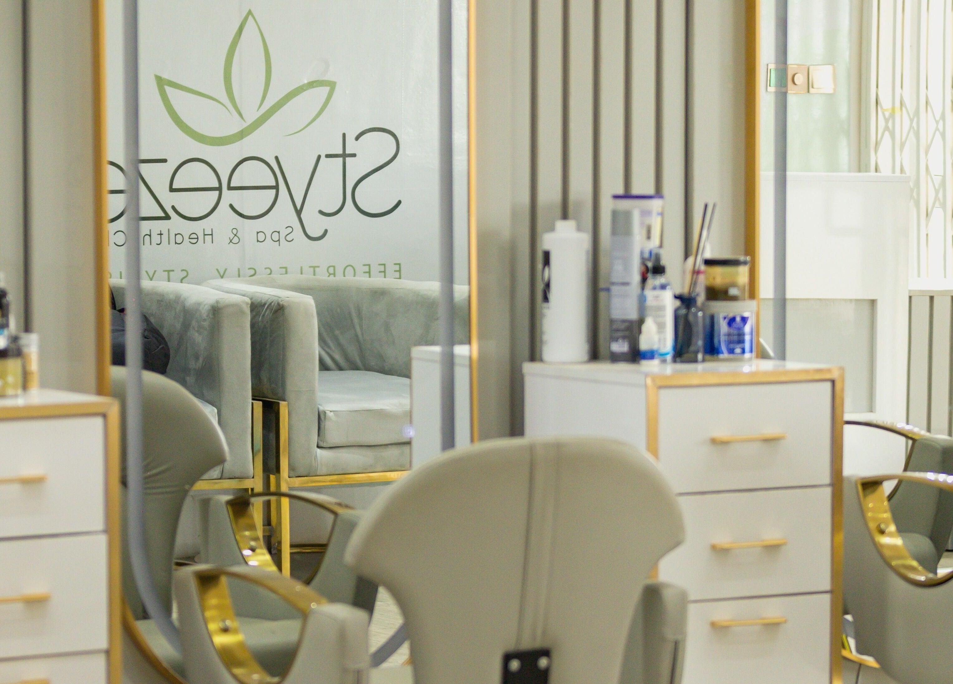 Modern salon interior at Styeeze Spa and Health Club, Greater Accra Region, GH, with stylish mirrors and chairs.