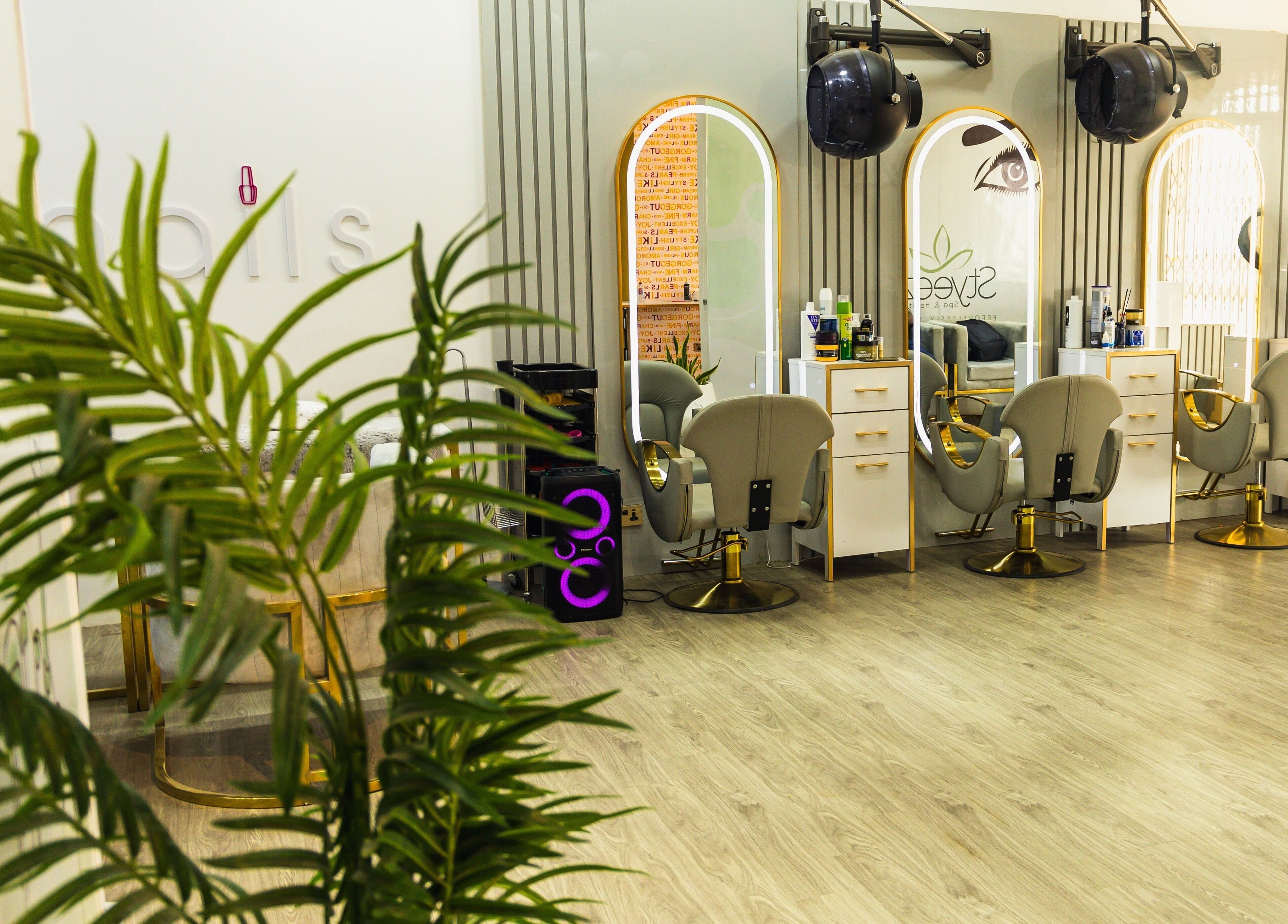Interior of Styeeze Spa and Health Club in Greater Accra Region, showcasing modern salon chairs and mirrors.