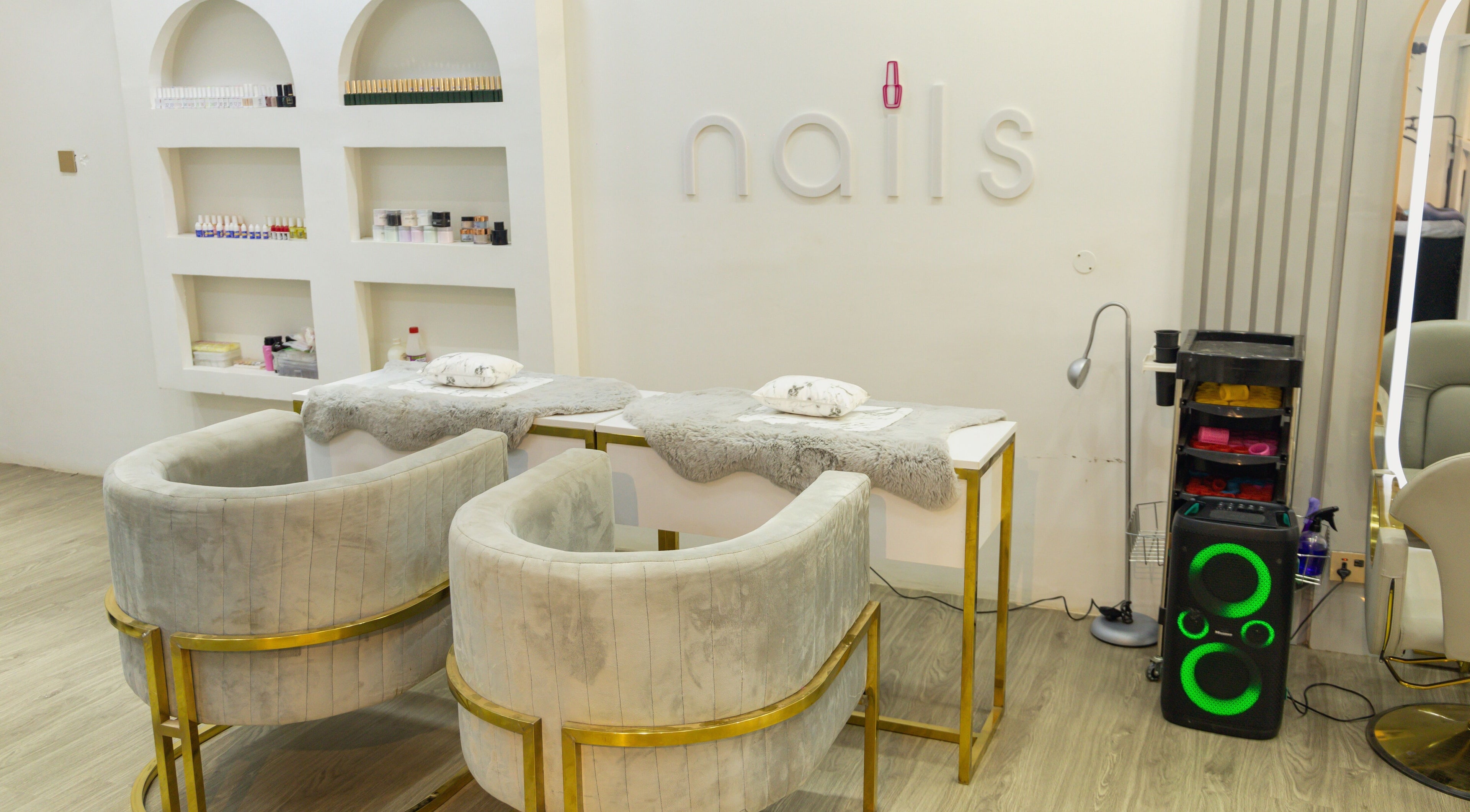 Nail station at Styeeze Spa and Health Club, Greater Accra Region, GH, featuring plush chairs and elegant decor.