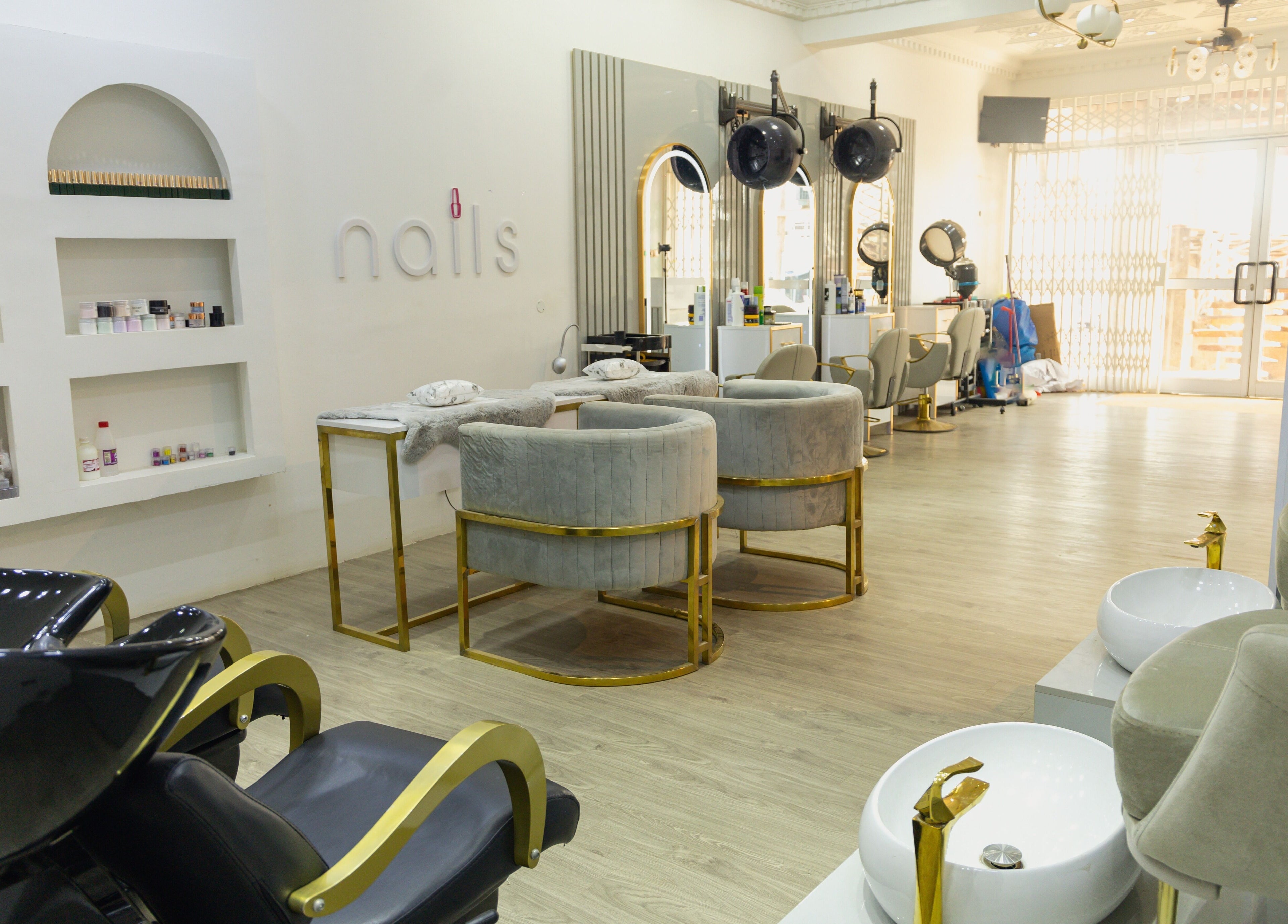 Luxurious interior of Styeeze Spa and Health Club in Greater Accra Region, GH, featuring plush seating and nail stations.