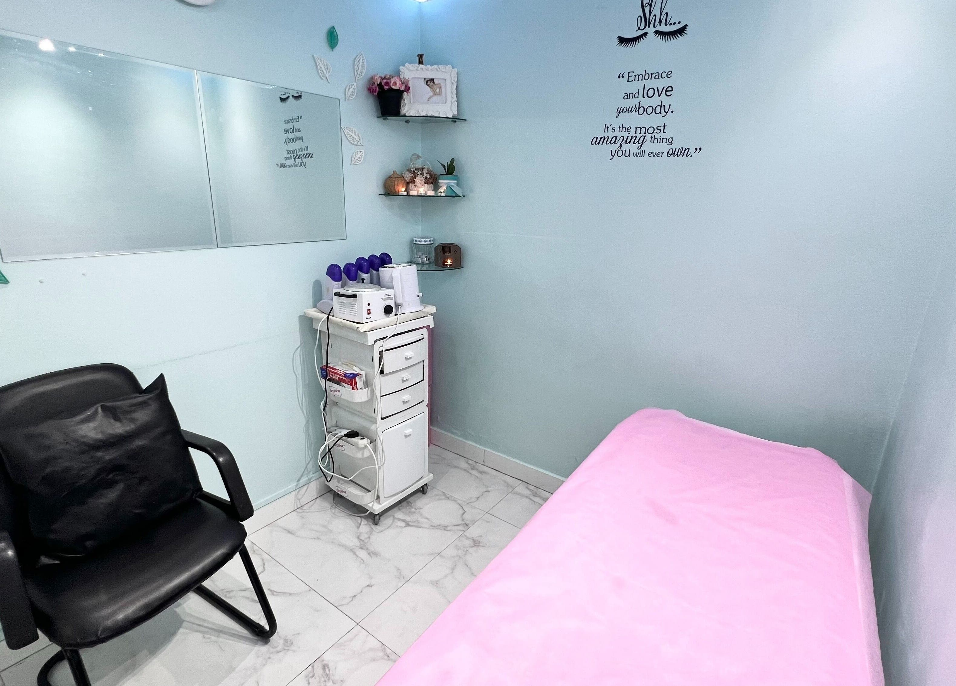 A tranquil treatment room at Winter Beauty Salon And Spa, Abu Dhabi, AE, featuring a pink massage bed.