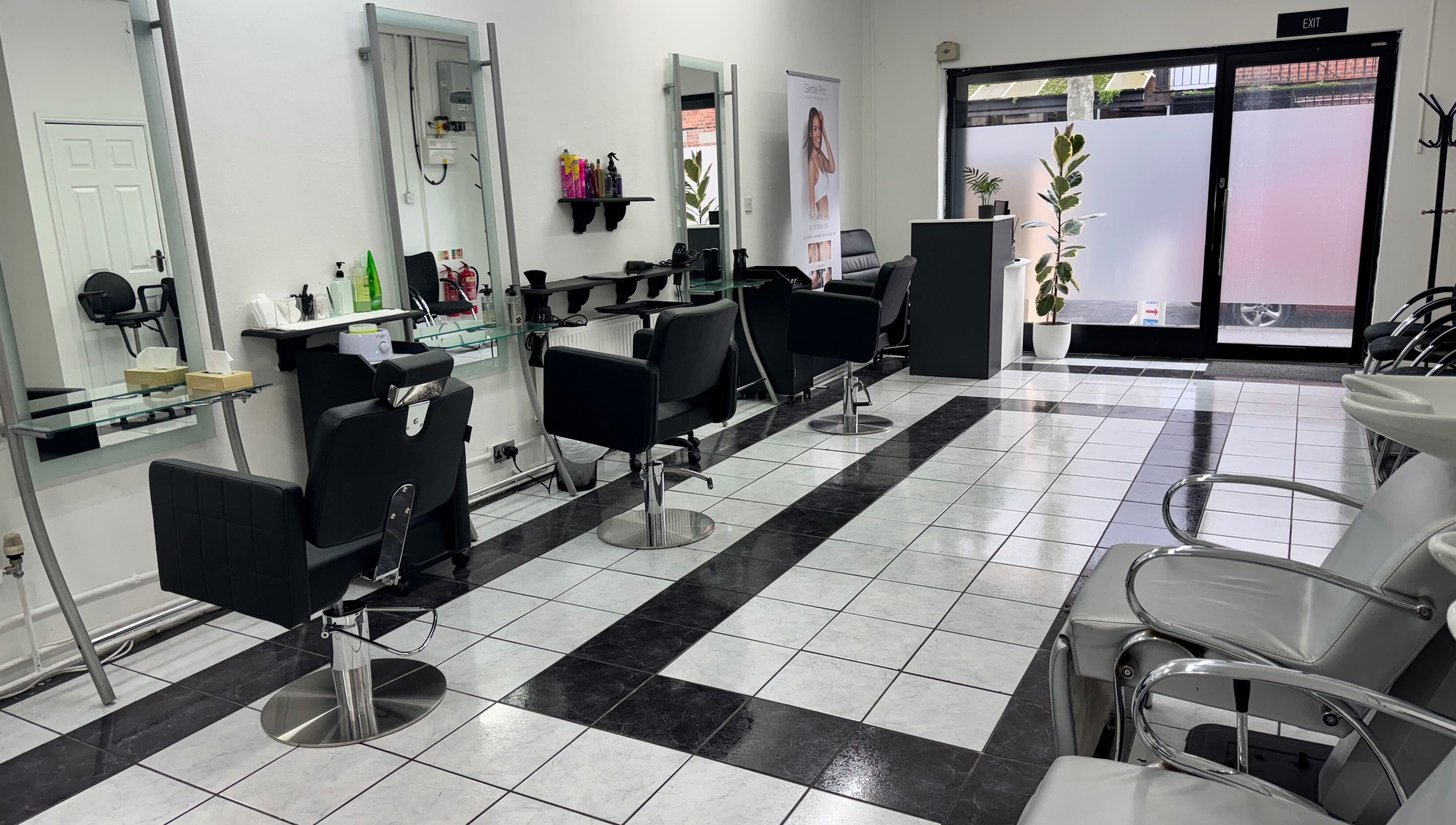 Modern salon interior at Ruby’s Hair Skin & Laser, London, England, GB, featuring sleek styling stations.