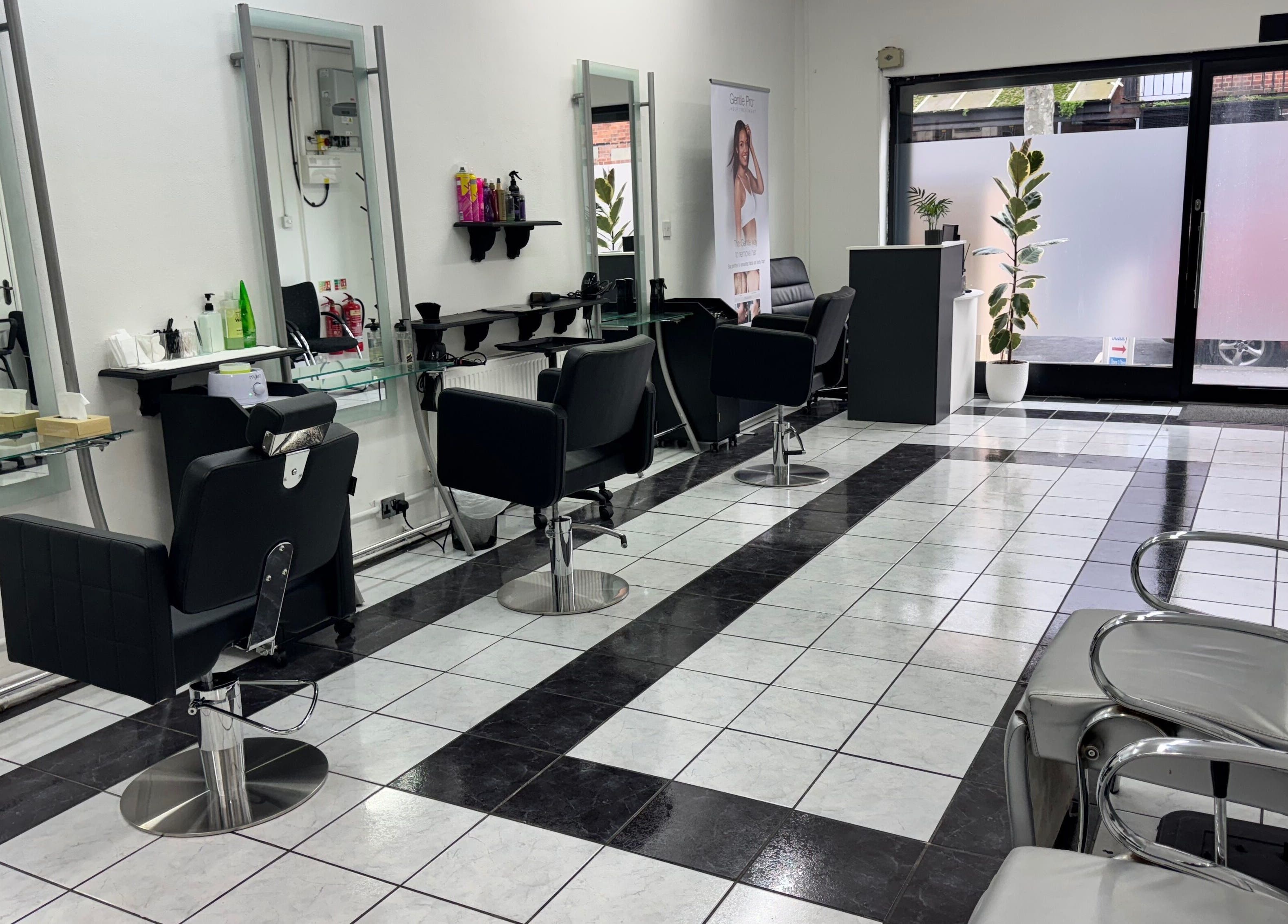 Modern salon interior at Ruby’s Hair Skin & Laser, London, England, GB, featuring sleek styling stations.