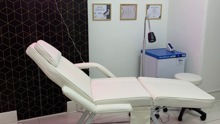 Modern treatment room at Harley Beauty Aesthetic Clinic in Ilford, England, GB with comfortable white chair.