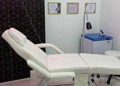 Modern treatment room at Harley Beauty Aesthetic Clinic in Ilford, England, GB with comfortable white chair.