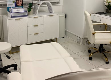 Modern treatment room at Harley Beauty Aesthetic Clinic, Ilford, England, GB featuring elegant white decor.