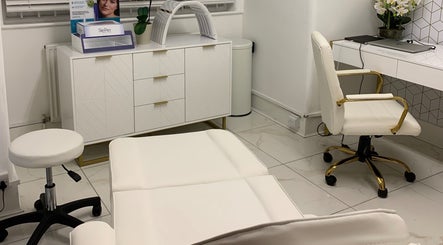 Modern treatment room at Harley Beauty Aesthetic Clinic, Ilford, England, GB featuring elegant white decor.