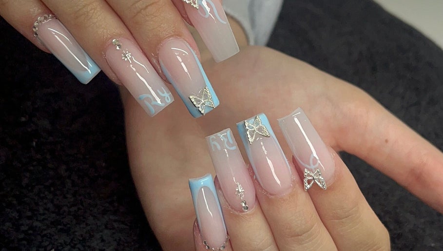 Stylish nail art with blue tips and butterflies at Byellwhite, Blackpool, England, GB.