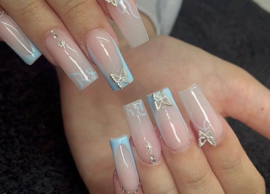 Stylish nail art with blue tips and butterflies at Byellwhite, Blackpool, England, GB.