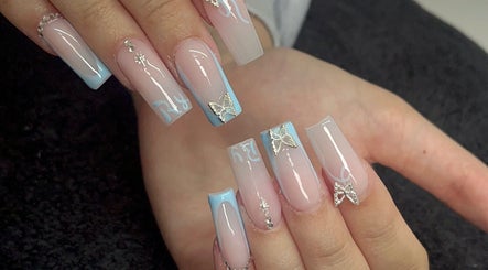 Stylish nail art with blue tips and butterflies at Byellwhite, Blackpool, England, GB.