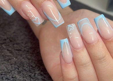 Stylish blue manicure at Byellwhite, Blackpool, England, GB offers elegance with heart designs.
