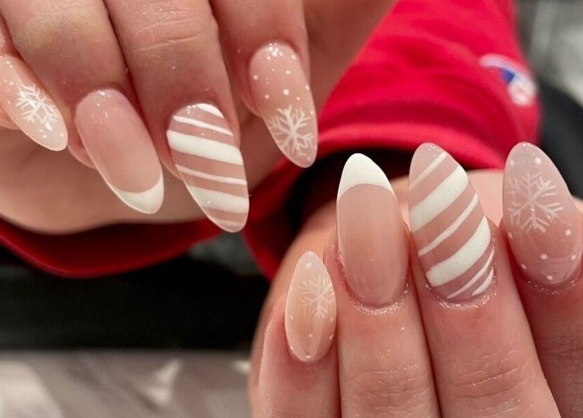 Festive nail art at Polished Perfect Nanaimo, Nanaimo, British Columbia, CA with snowflakes and stripes.