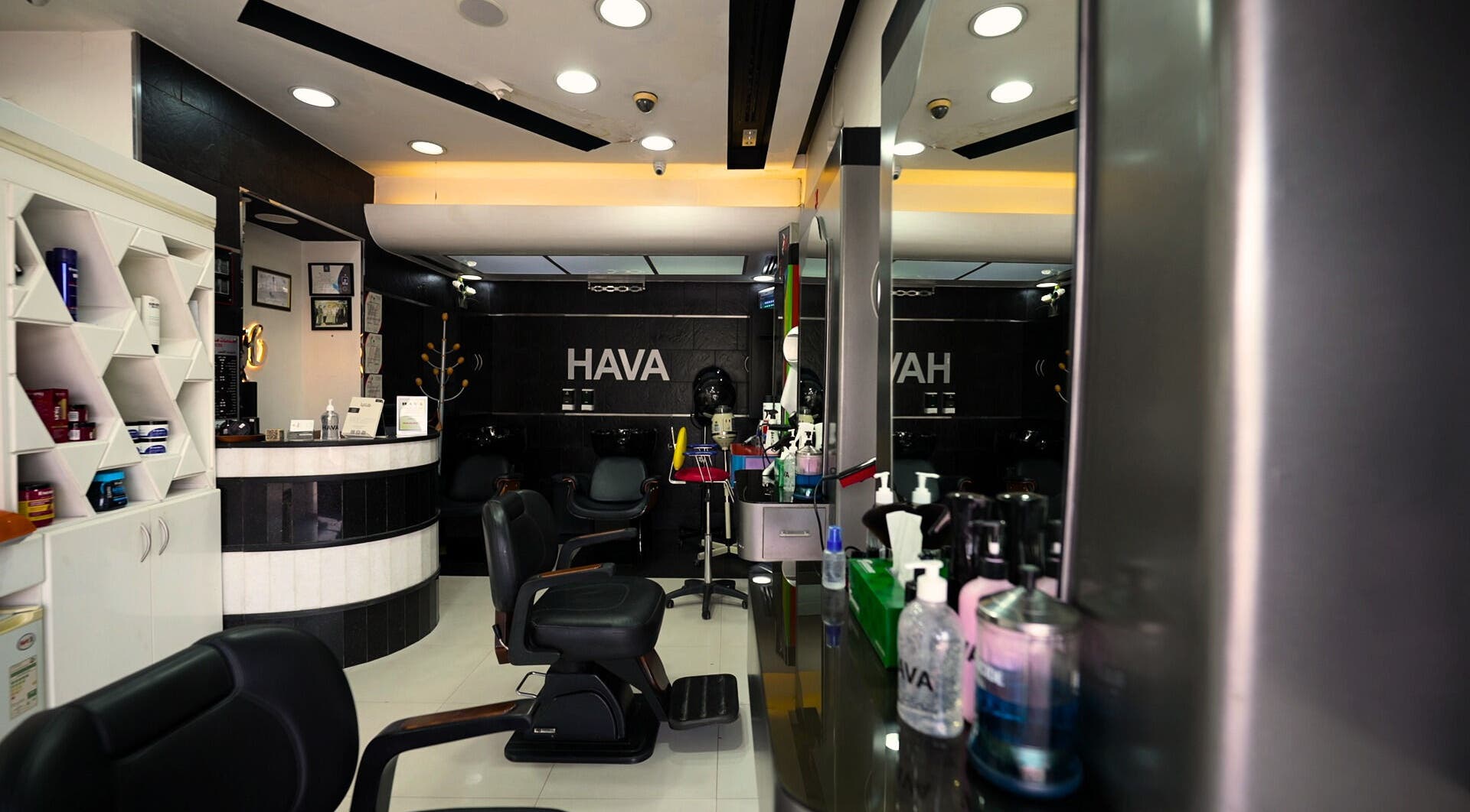 Interior of Hava Gents Salon - Nuaymia, Ajman, Ajman, AE with modern black chairs and organized products.