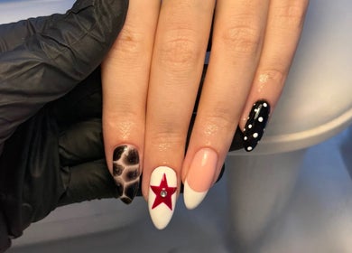 Elegant nail art design with star and polka dots by Cerys Nails, Warrington, England, GB.