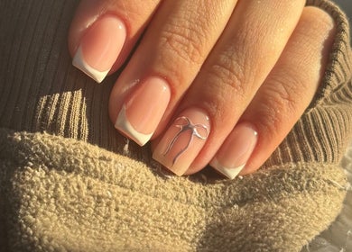 Elegant French manicure with bow design By Cerys Nails, Warrington, England, GB