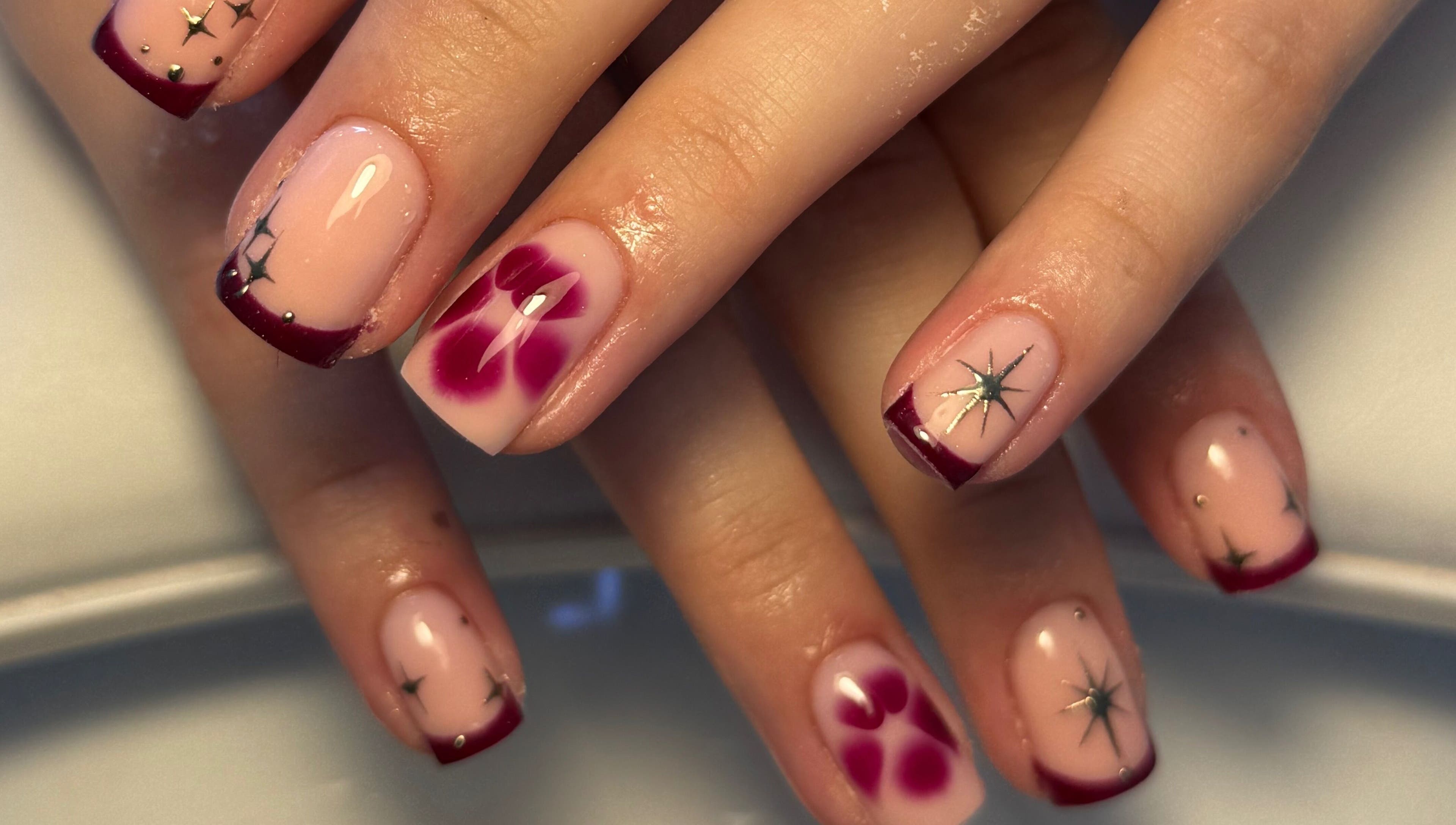 Elegant floral and star nail art manicure by Cerys Nails in Warrington, England, GB.