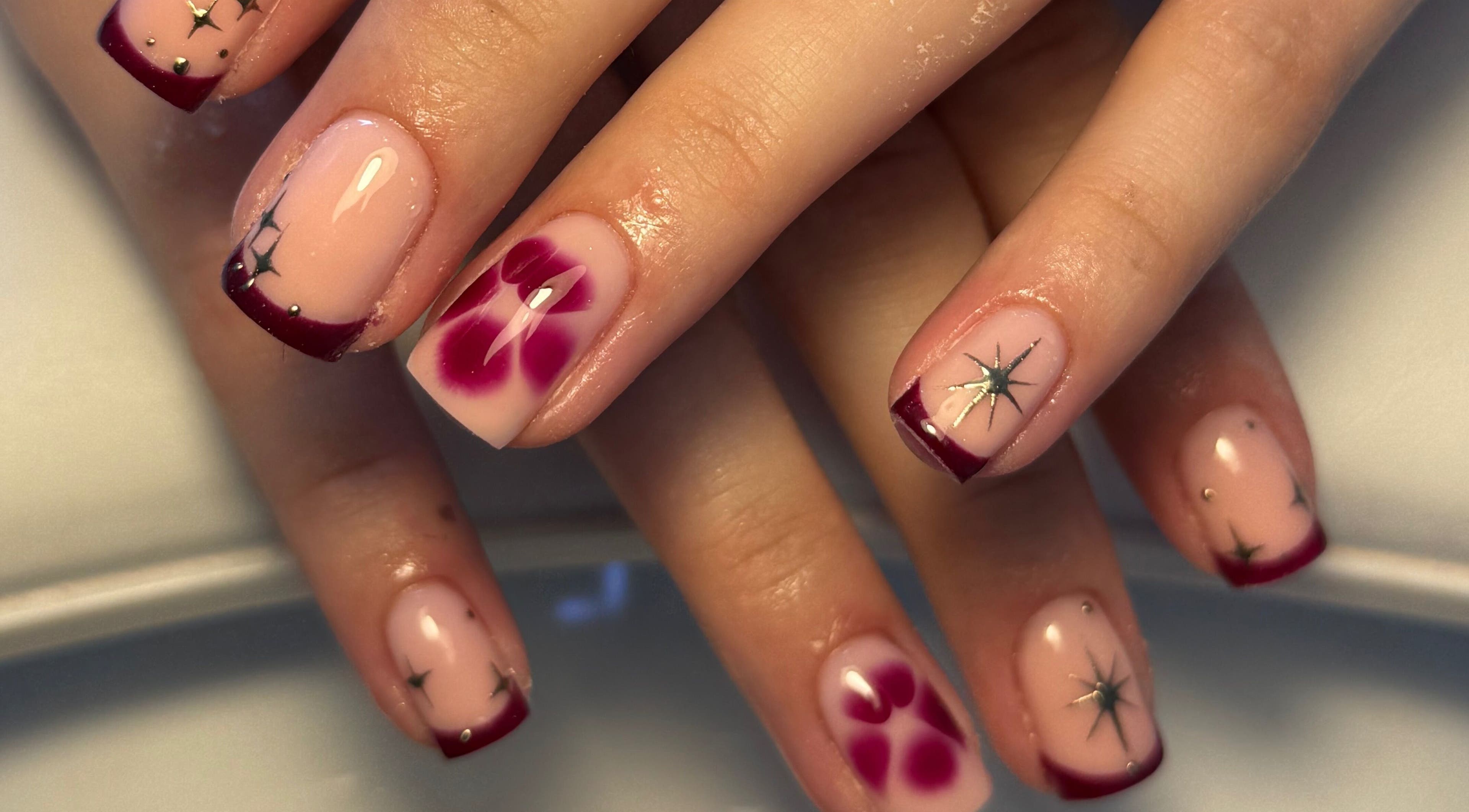 Elegant floral and star nail art manicure by Cerys Nails in Warrington, England, GB.