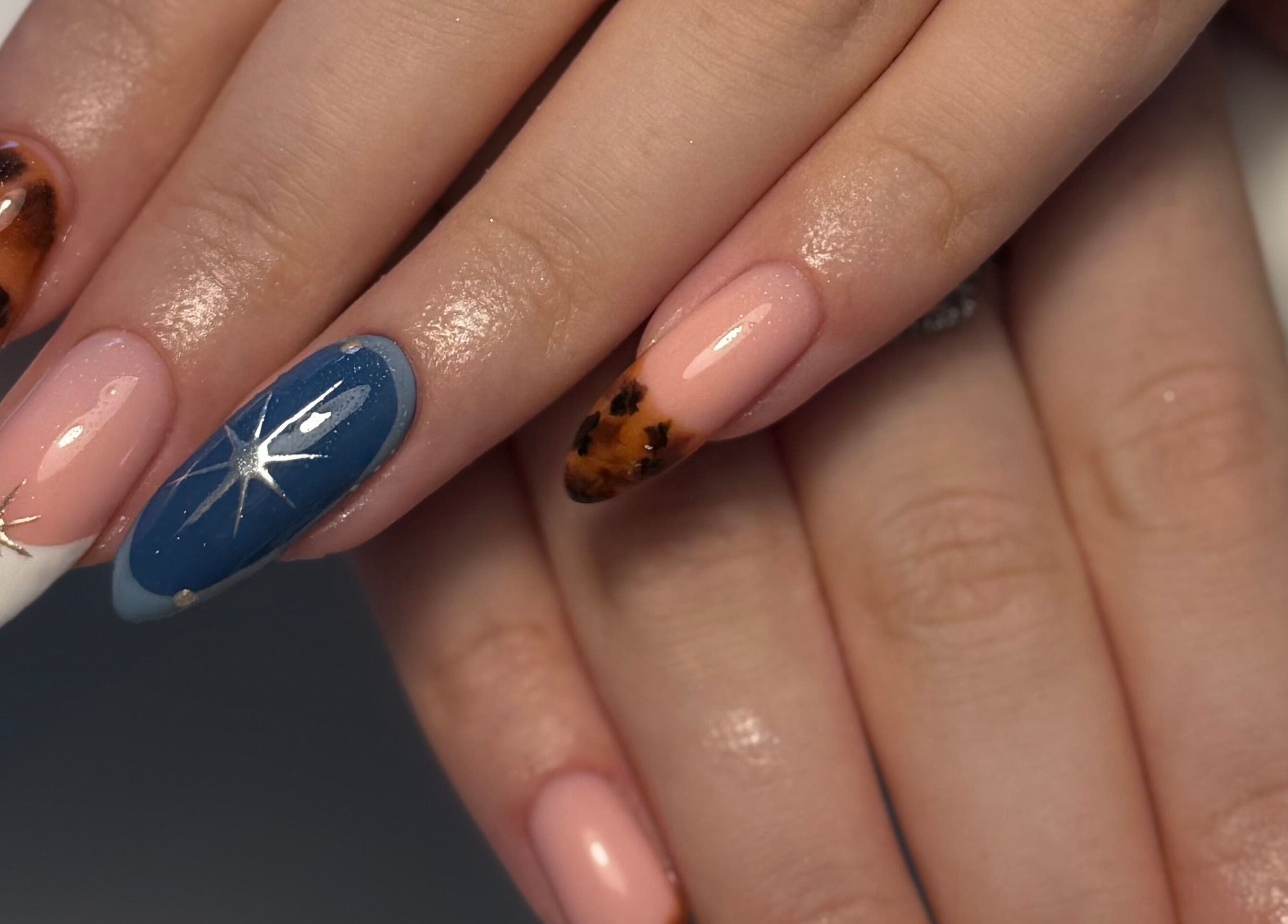 Elegant nail art featuring star designs at By Cerys Nails, Warrington, England, GB. Perfect for a glam look.