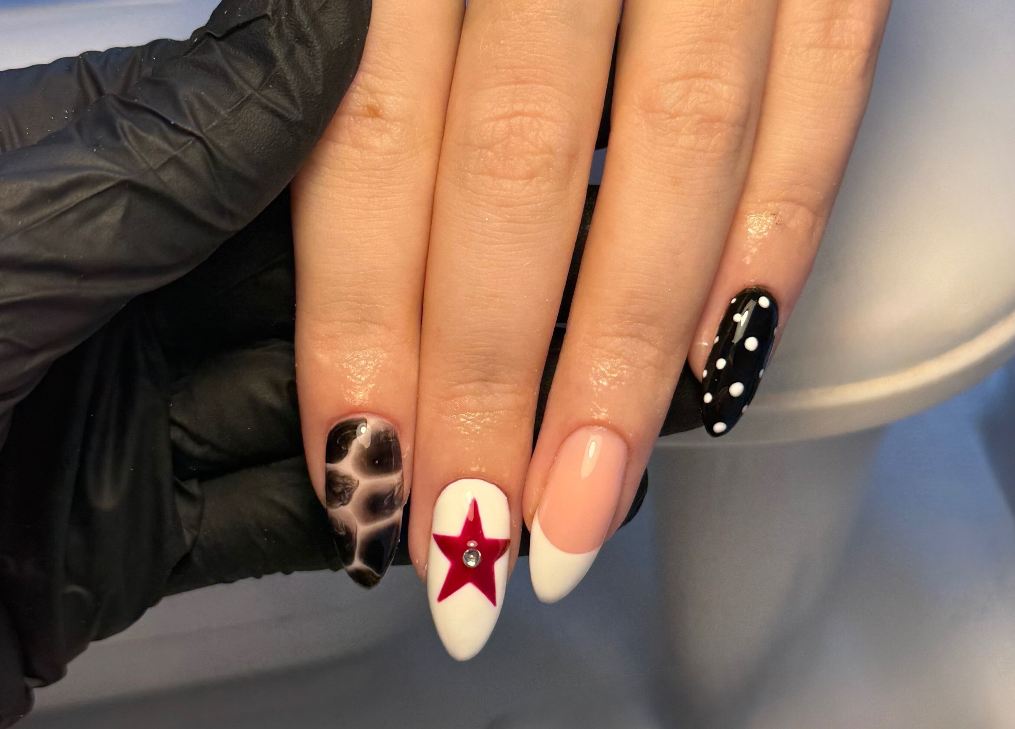 Stylish nail art with a red star at By Cerys Nails, Warrington, England, GB.