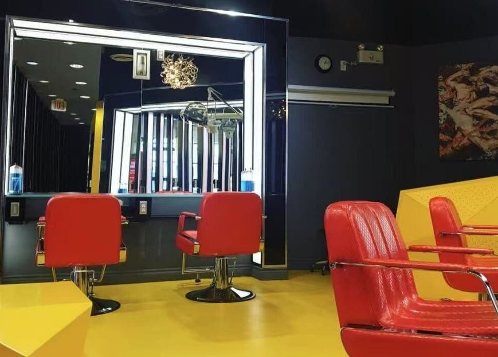 Interior of Air Plus Hair Salon at Metrotown in Burnaby, BC, showcasing modern red chairs and mirrors.