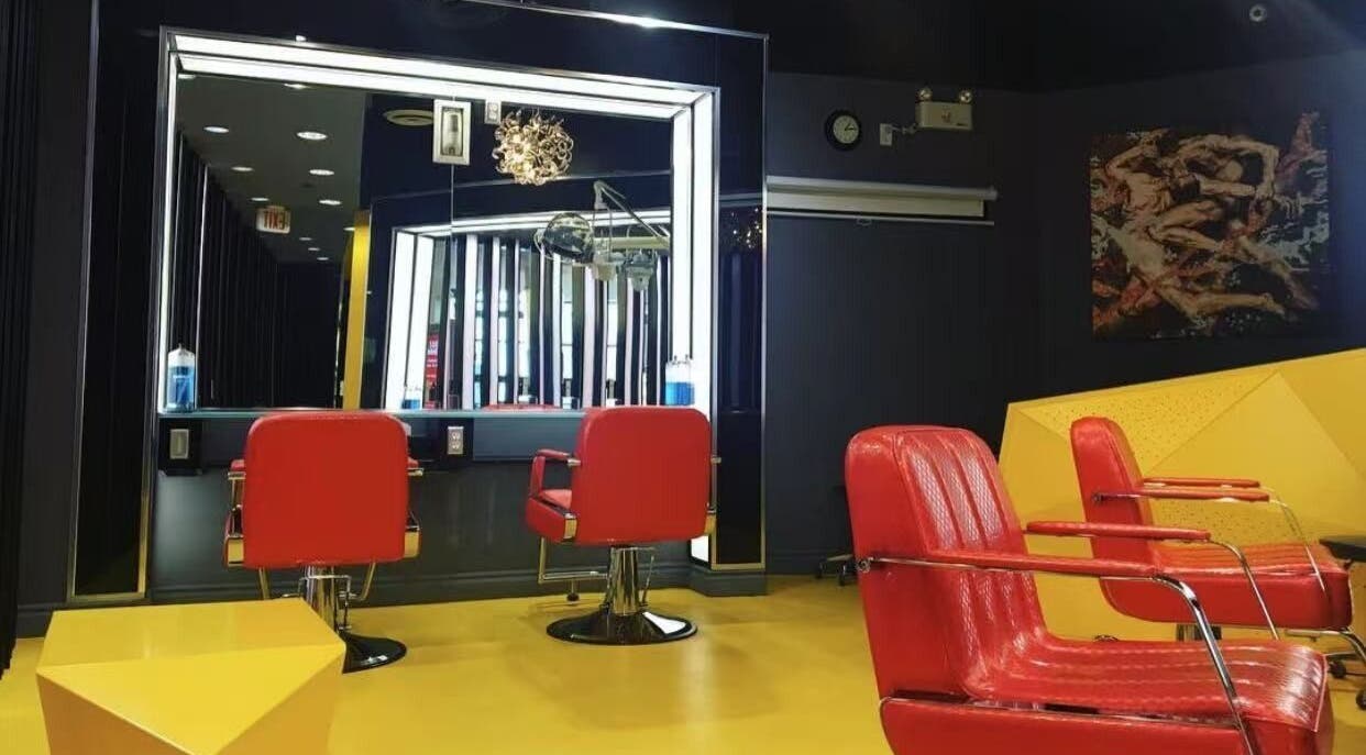 Interior of Air Plus Hair Salon at Metrotown in Burnaby, BC, showcasing modern red chairs and mirrors.