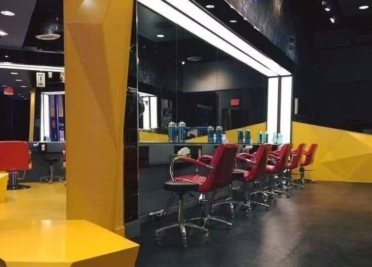 Modern interior of Air Plus Hair Salon at Metrotown, Burnaby, British Columbia, CA with stylish decor and red chairs.
