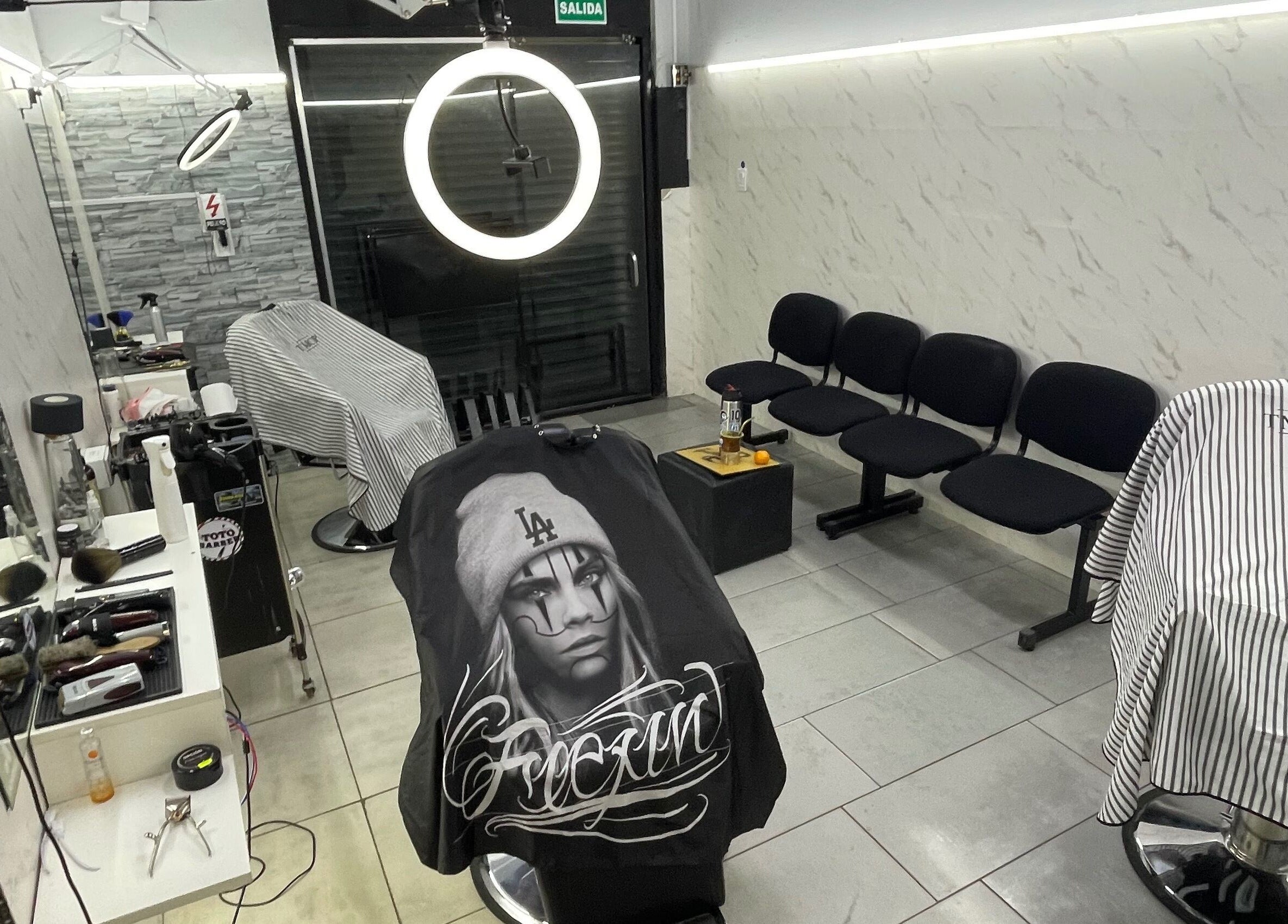 Interior moderno de Toto Barber en San Andres, Provincia De Buenos Aires, AR, con sillas elegantes y herramientas estilísticas.