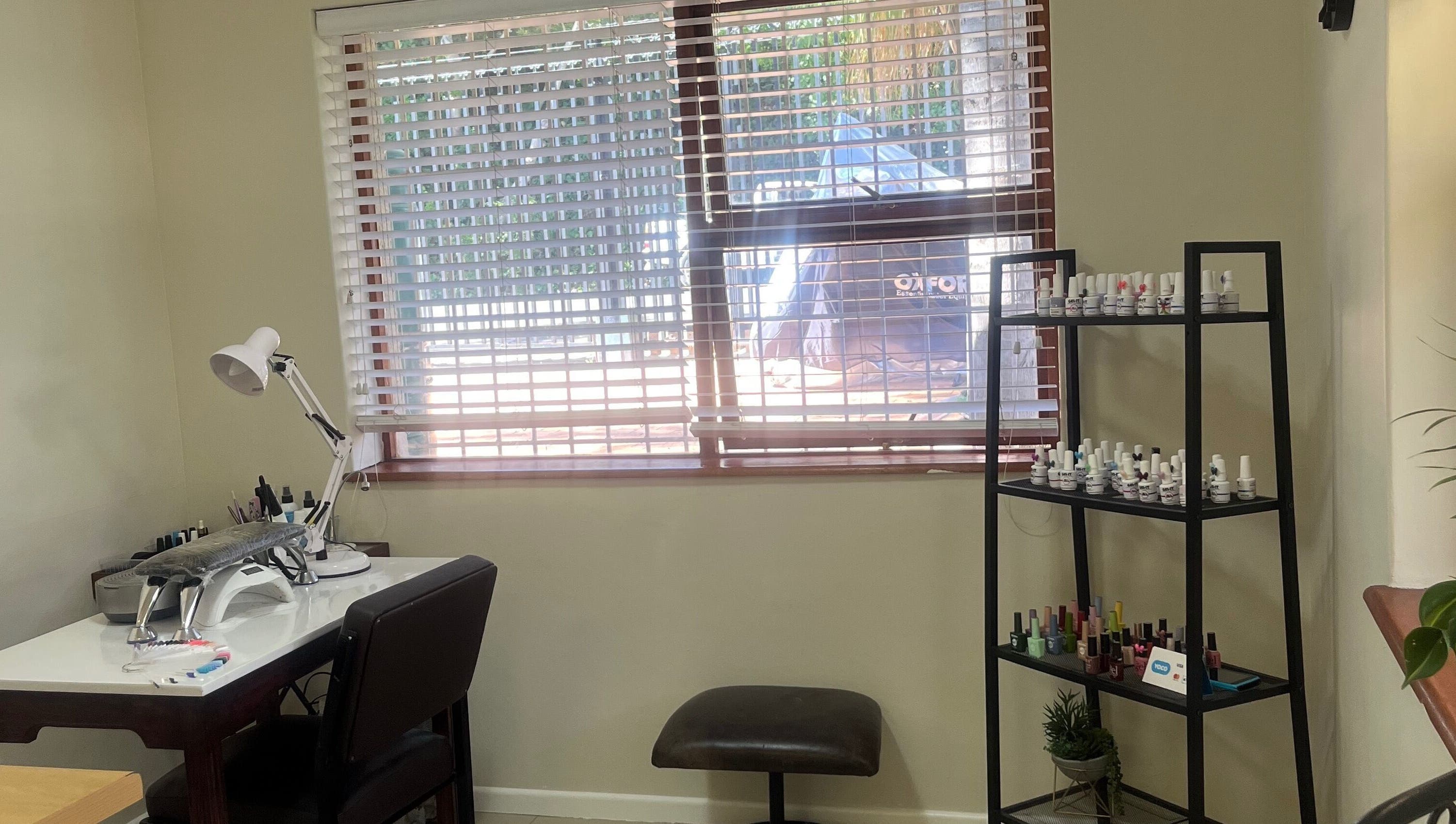 Sage nail and beauty workspace with nail polish rack, Cape Town, Western Cape, ZA.