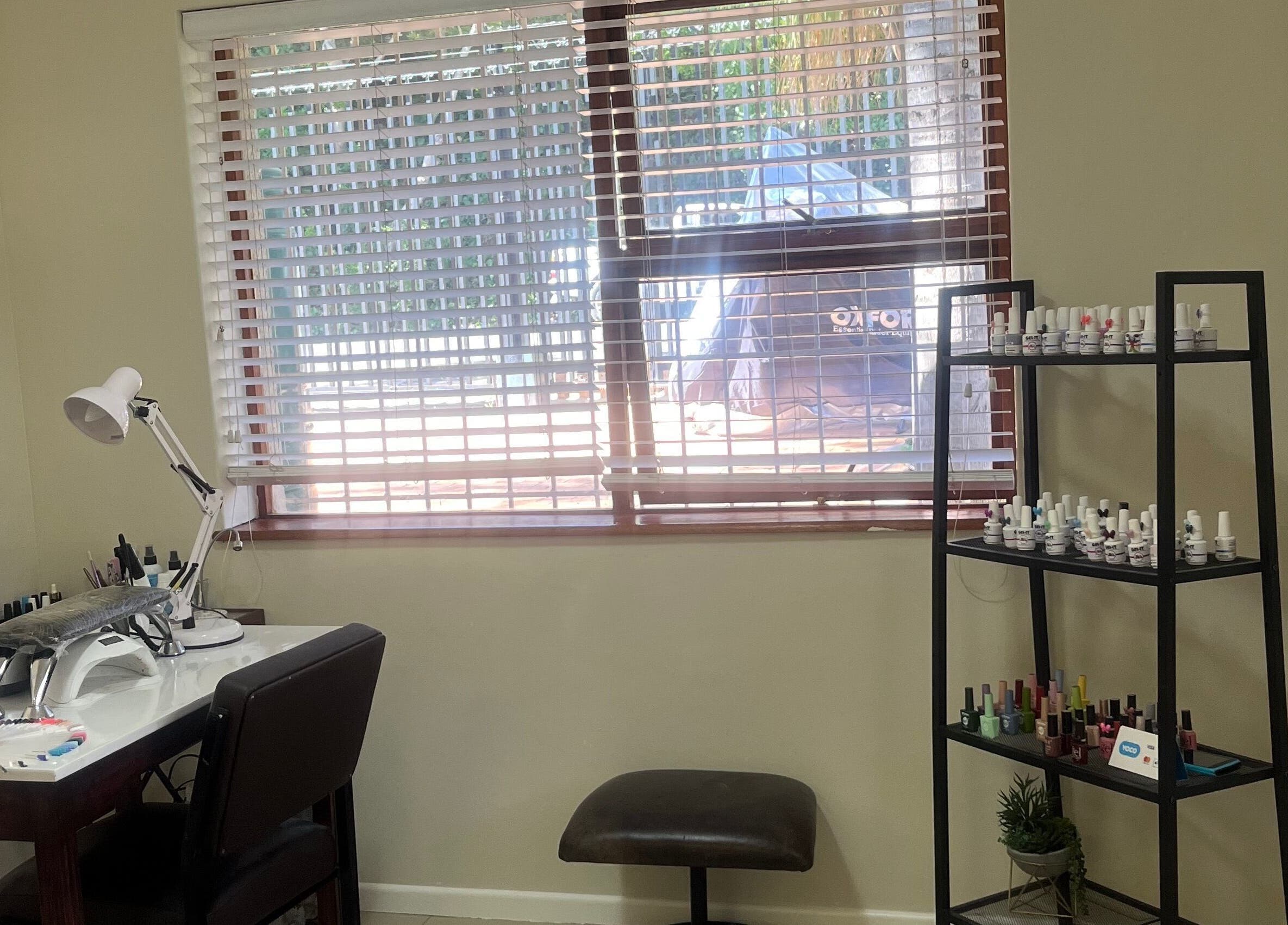 Sage nail and beauty workspace with nail polish rack, Cape Town, Western Cape, ZA.