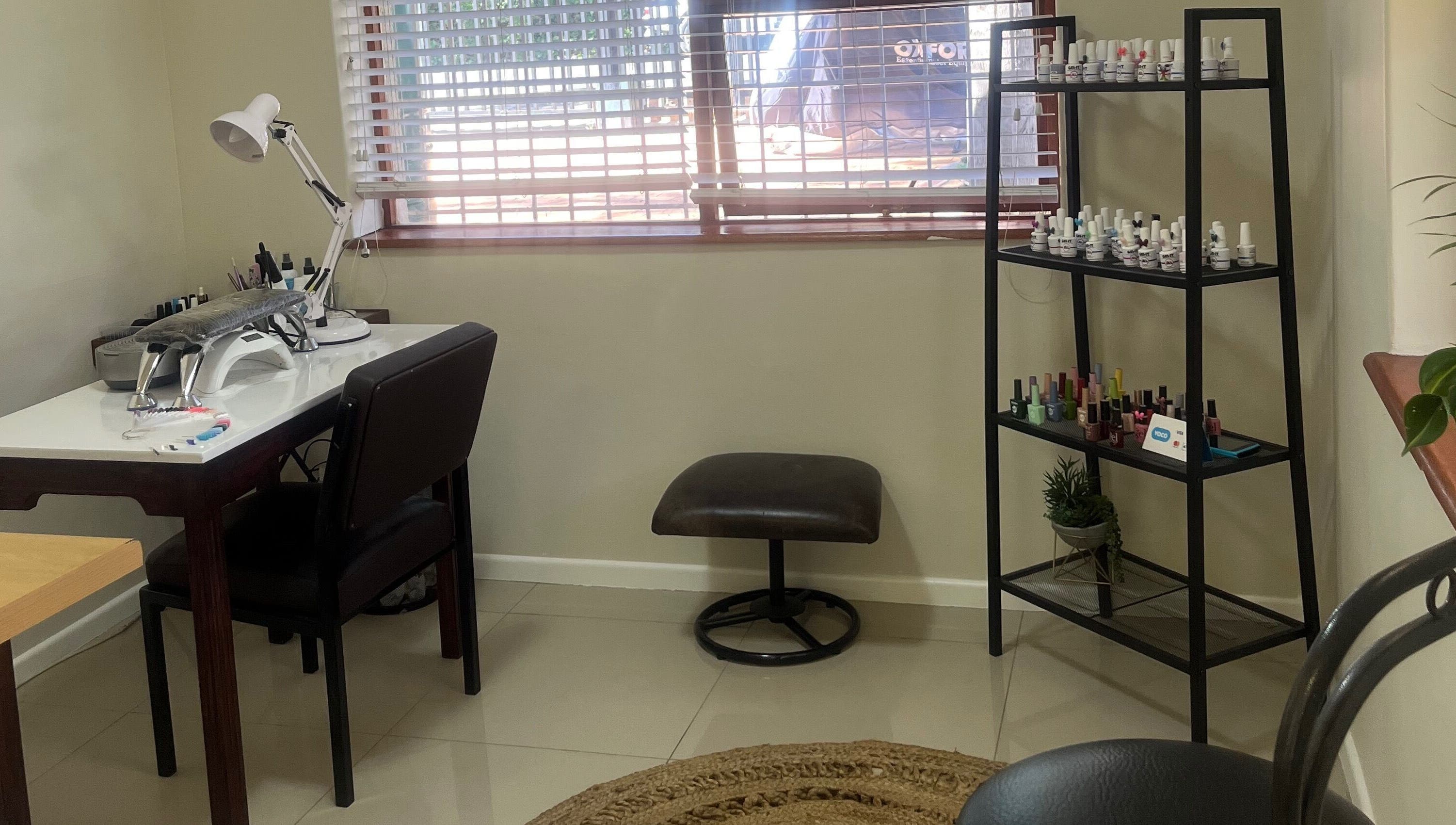 Cozy nail station at Sage Nail and Beauty, Cape Town, Western Cape, ZA, featuring polishes and tools.