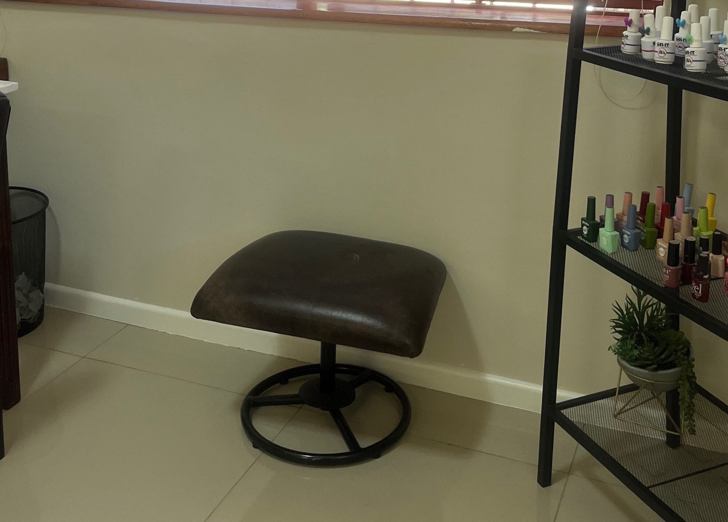 Comfortable seating and nail polish display at Sage Nail and Beauty in Cape Town, Western Cape, ZA.