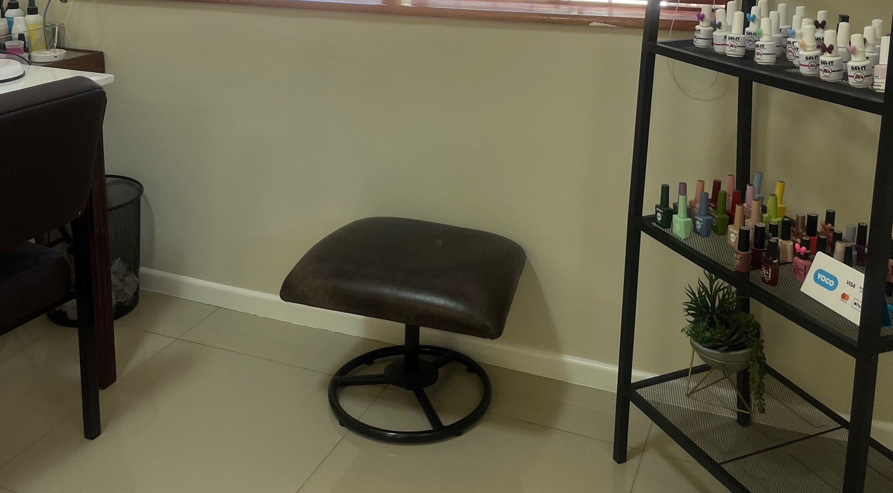 Comfortable seating and nail polish display at Sage Nail and Beauty in Cape Town, Western Cape, ZA.