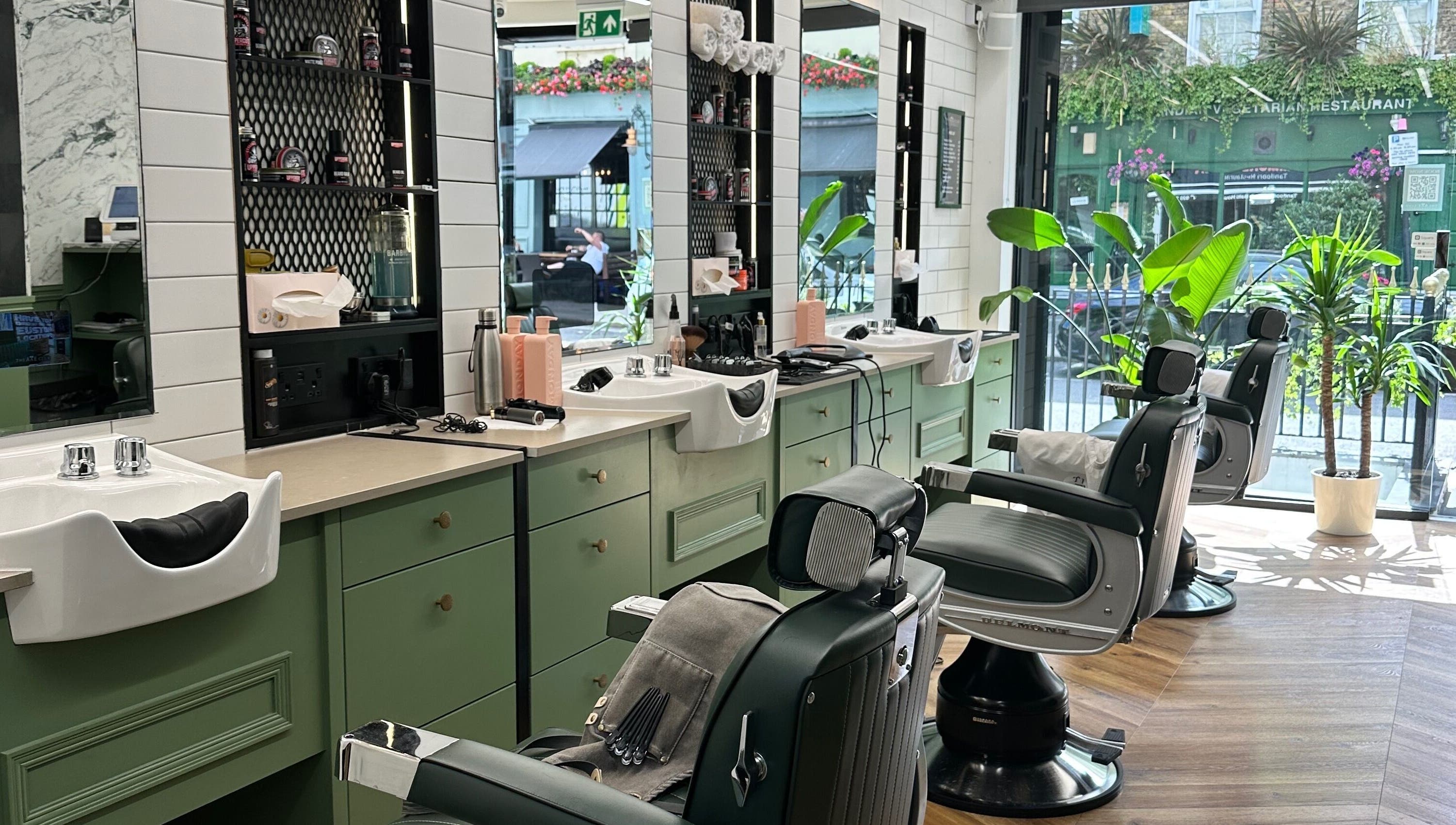 Stylish barber chairs and mirrors at The Axe Club - Euston in London, England, GB.