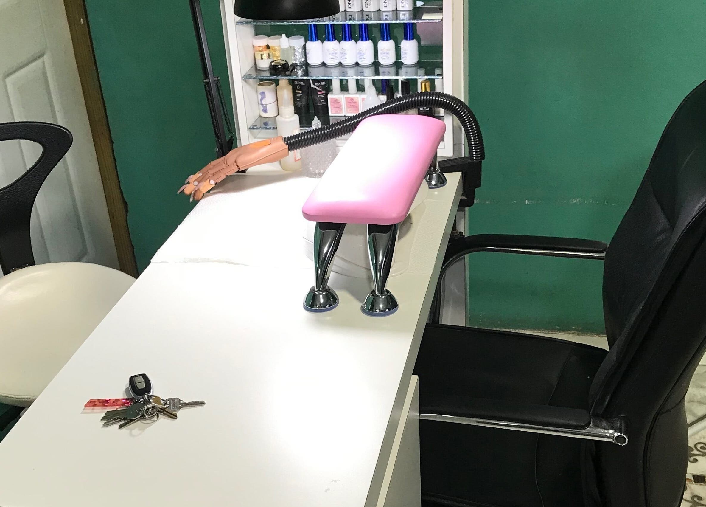 Manicure station at Pure Posh Nails in Browns Town, St. Ann Parish, JM, showcasing tools and seating.