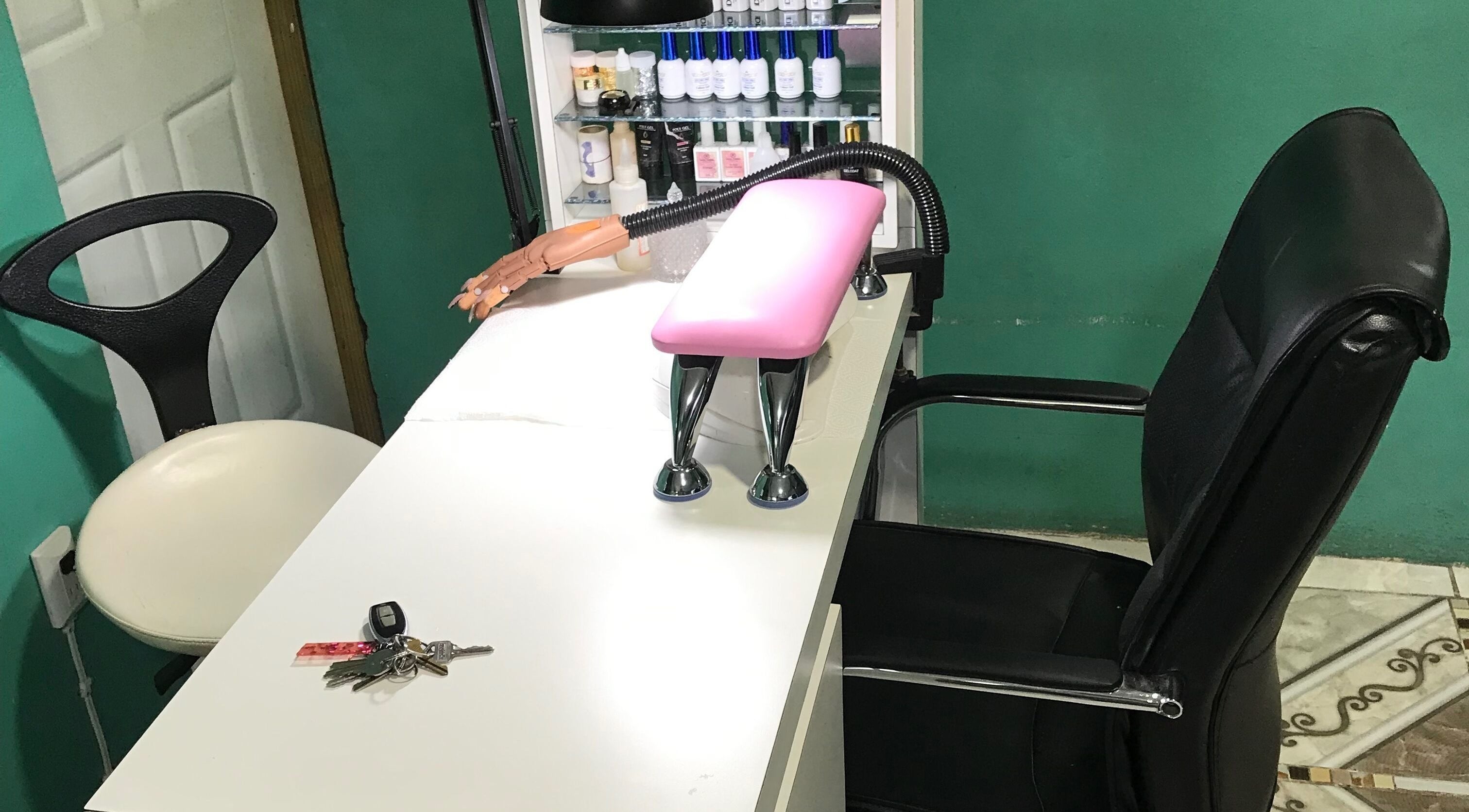Manicure station at Pure Posh Nails in Browns Town, St. Ann Parish, JM, showcasing tools and seating.