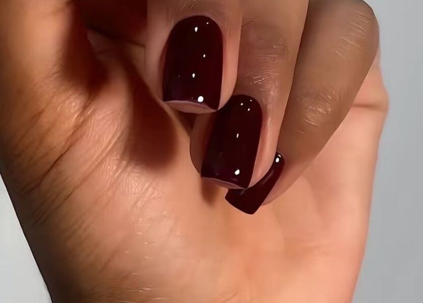 Burgundy nails with gloss finish at Pure Posh Nails, Browns Town, St. Ann Parish, JM. Luxurious manicure close-up.