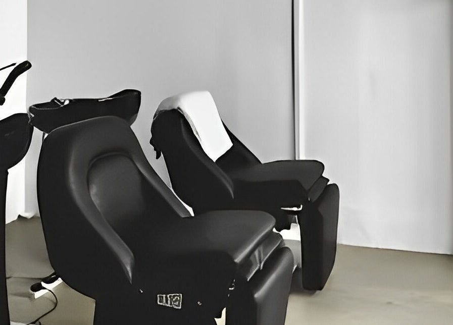 Comfortable black salon chairs at Kutsurogi in Singapore, Singapore, SG, ideal for relaxing hair treatments.