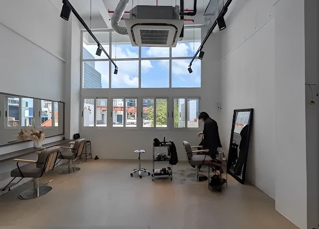 Bright, modern salon interior at Kutsurogi, Singapore, Singapore, SG, featuring stylist chairs and mirrors.