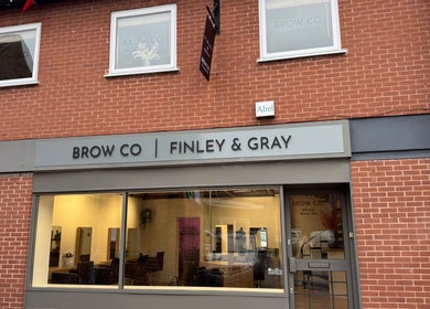Exterior facade of The Brow Co. in Loughborough, England, GB, showcasing elegant signage.