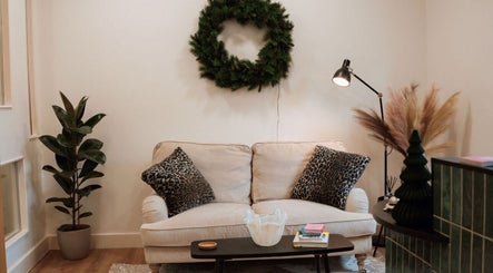 Elegant lounge at The Brow Co. in Loughborough, England. Cozy sofa with stylish decor creating inviting atmosphere.