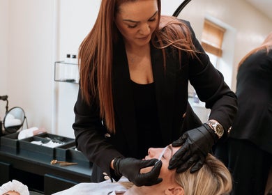 Expert brow shaping at The Brow Co., Loughborough, England, GB with attentive stylist for perfect results.