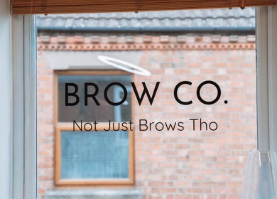 The Brow Co. window sign in Loughborough, England, GB showcases stylish beauty branding.