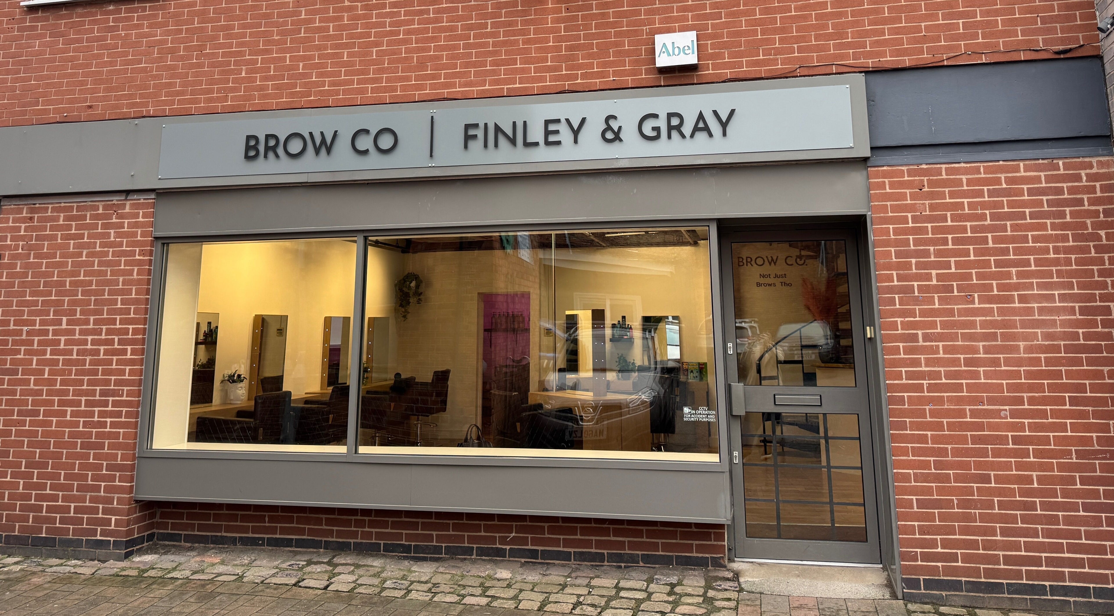 Front view of The Brow Co. in Loughborough, England, GB showing large window and stylish entrance.