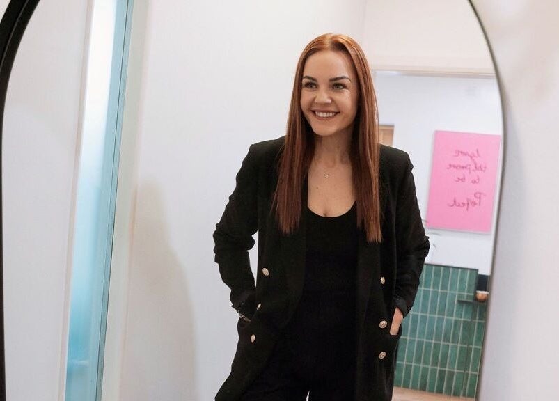 Client smiling in chic attire at The Brow Co., Loughborough, England, GB.