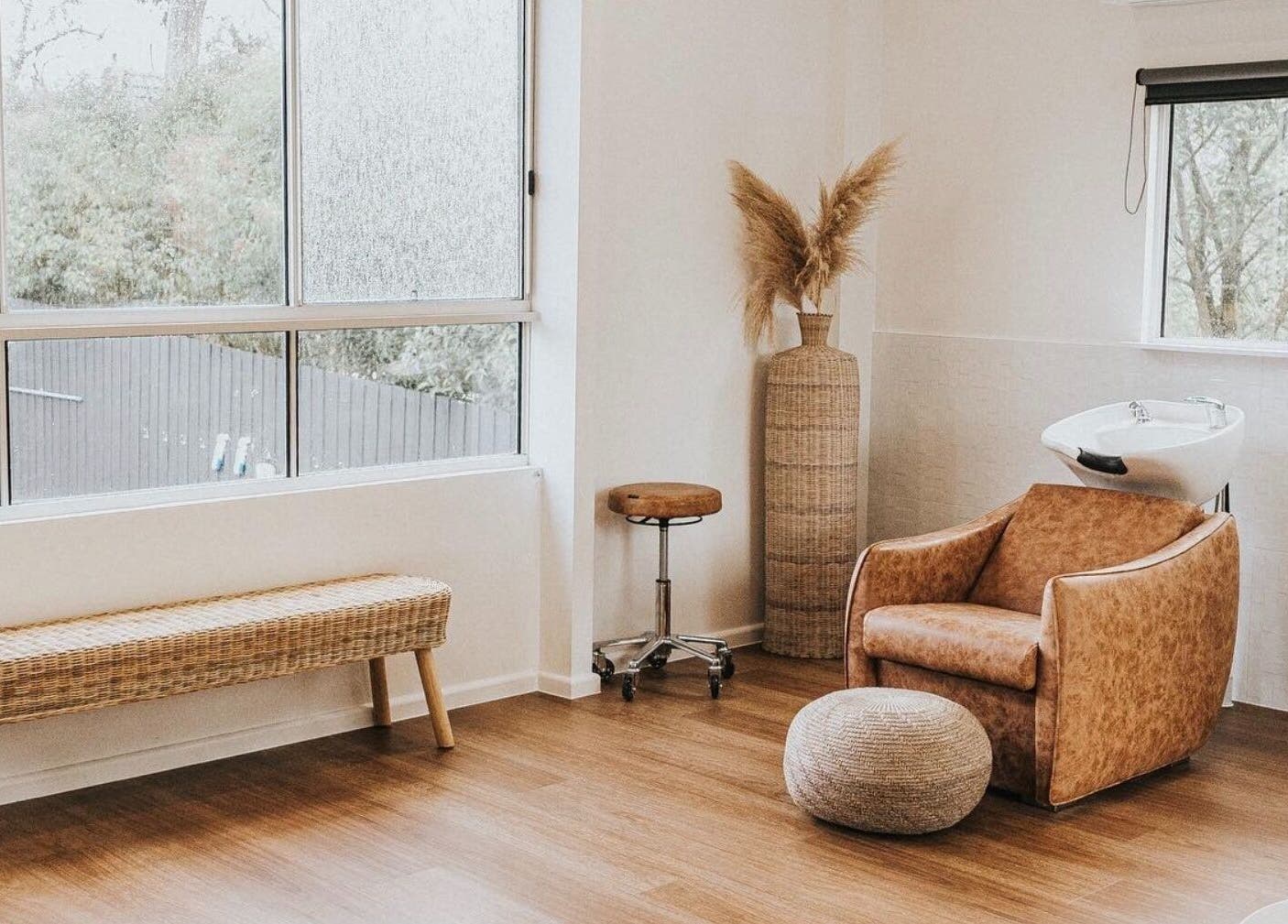 Calming interior of Artistry Lane by Jessie Lee in Melbourne, Victoria, AU featuring a stylish salon chair by a large window.