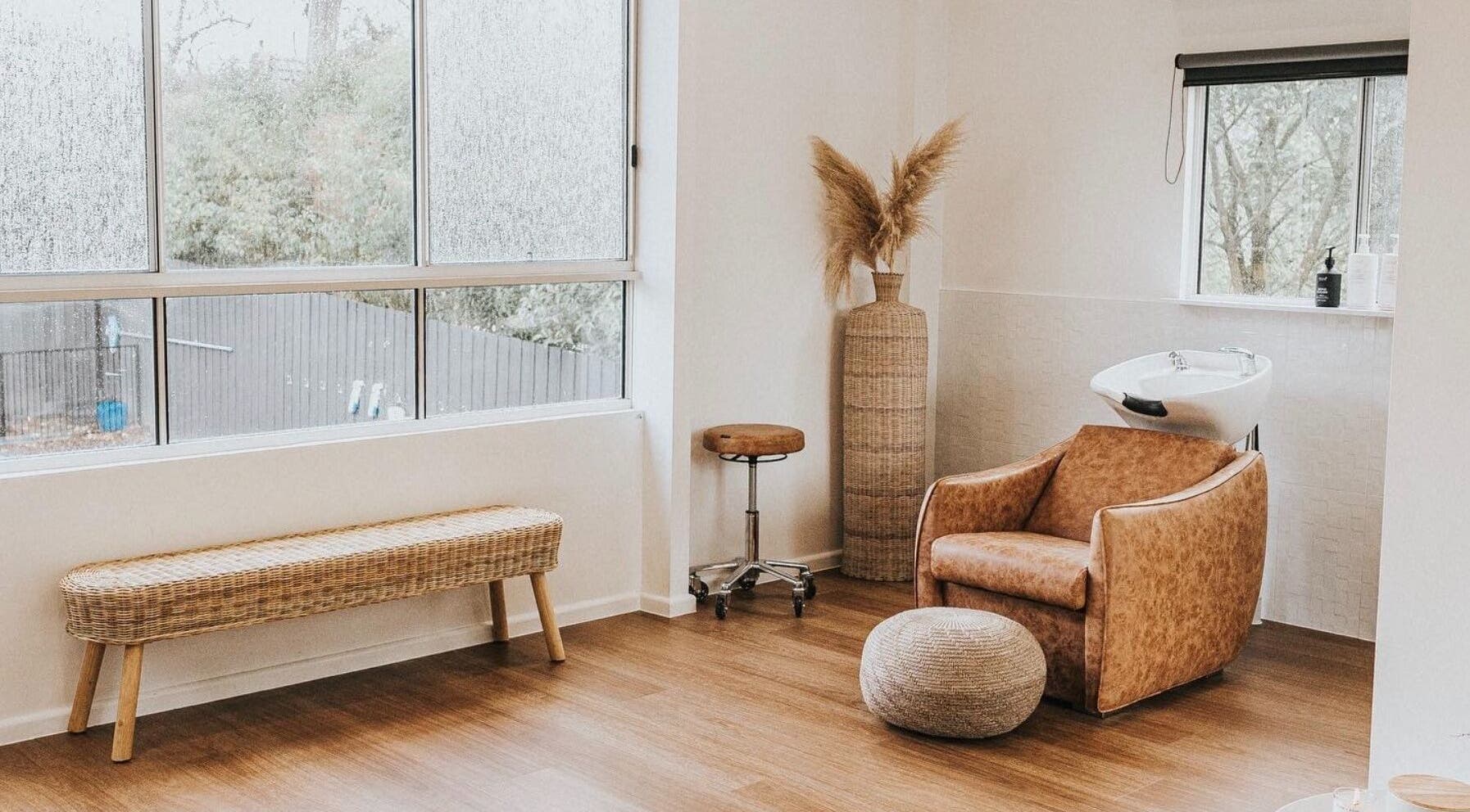 Calming interior of Artistry Lane by Jessie Lee in Melbourne, Victoria, AU featuring a stylish salon chair by a large window.