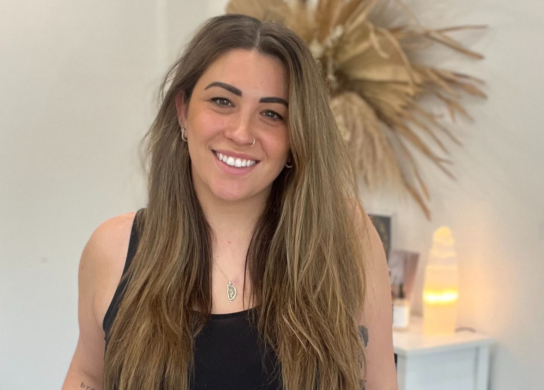 Smiling individual at Artistry Lane by Jessie Lee, Melbourne, Victoria, AU, showcasing beauty and wellness space.