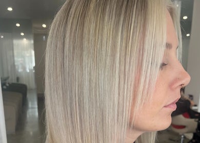 Sleek blonde hairstyle at Artistry Lane by Jessie Lee, Melbourne, Victoria, AU. Modern styling with smooth finish.